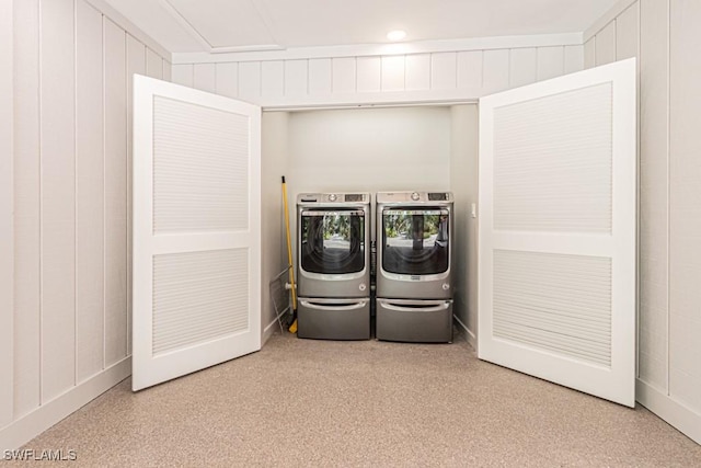 clothes washing area with washing machine and clothes dryer