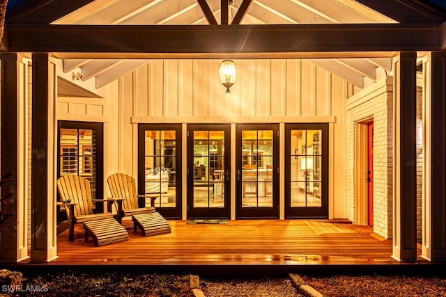 doorway to property featuring board and batten siding and a deck