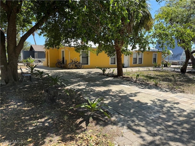 11688 Saunders Ave, Bonita Springs, FL 34135 - view of front of property with concrete driveway, stucco siding, and fence