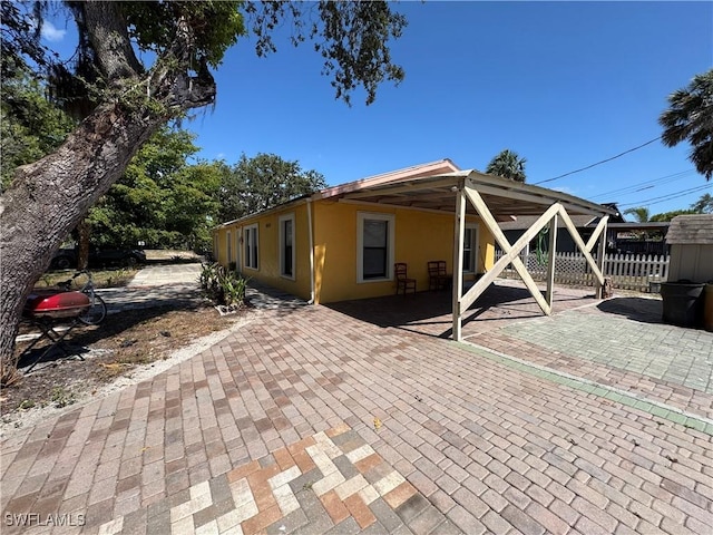 11688 Saunders Ave, Bonita Springs, FL 34135 - exterior space with a patio, stucco siding, and fence