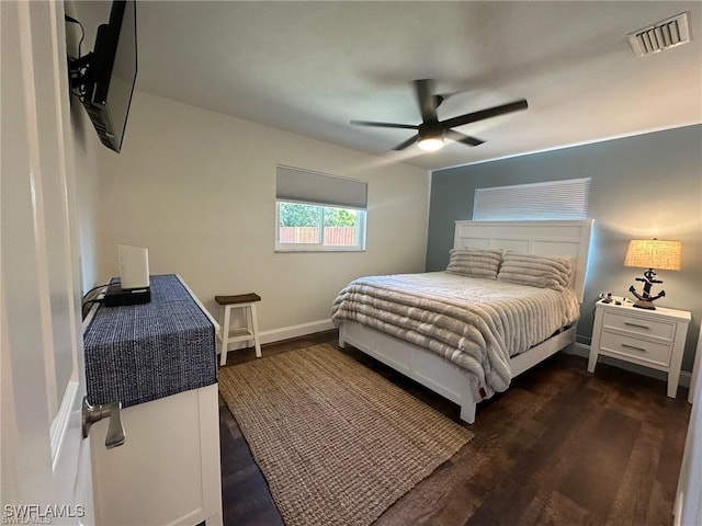 bedroom featuring dark wood finished floors, baseboards, and ceiling fan