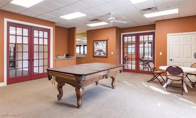playroom with french doors, pool table, healthy amount of natural light, light carpet, and a drop ceiling