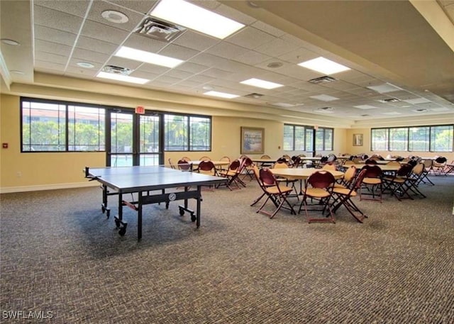 rec room featuring a paneled ceiling, carpet, and baseboards