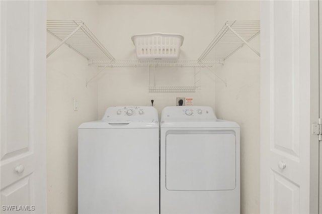 laundry area with washing machine and clothes dryer