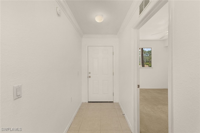 hallway with baseboards, light tile patterned flooring, and ornamental molding