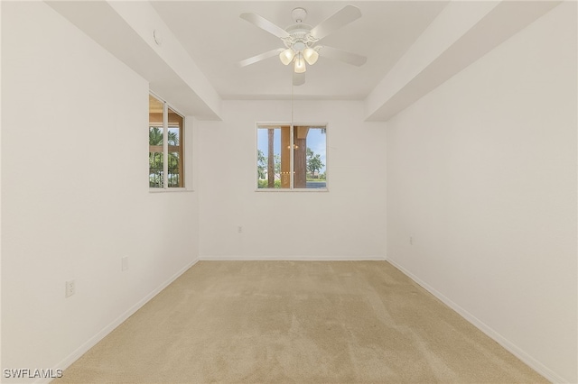 empty room with light carpet, ceiling fan, and baseboards