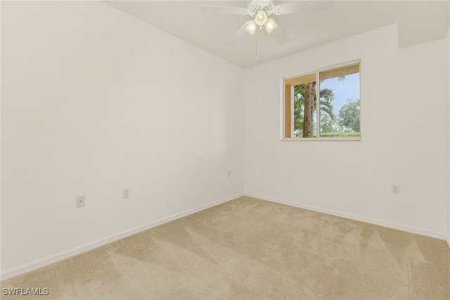 unfurnished room with light colored carpet, baseboards, and ceiling fan