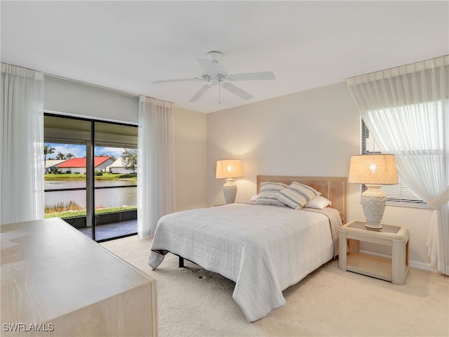 13111 Cross Creek Blvd Unit 208, Fort Myers, FL 33912 - bedroom with light colored carpet, access to exterior, a water view, and a ceiling fan