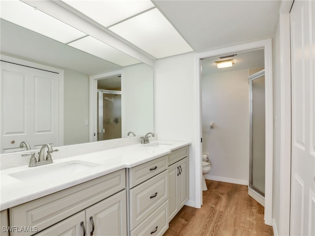 13111 Cross Creek Blvd Unit 208, Fort Myers, FL 33912 - full bath with toilet, a stall shower, double vanity, and wood finished floors
