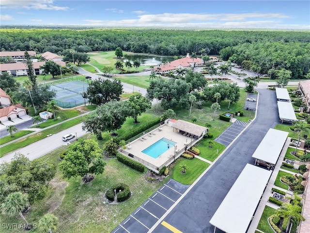13111 Cross Creek Blvd Unit 208, Fort Myers, FL 33912 - bird's eye view of a nearby body of water, a pool area, and a heavily wooded area
