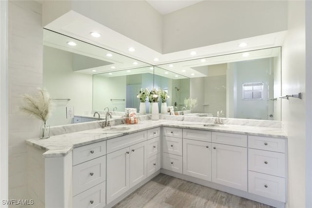 26271 Devonshire Ct Unit 202, Bonita Springs, FL 34134 - full bathroom with recessed lighting, double vanity, and wood finished floors