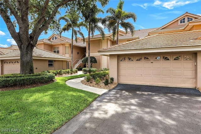 26271 Devonshire Ct Unit 202, Bonita Springs, FL 34134 - townhome / multi-family property featuring asphalt driveway, stucco siding, a tile roof, and a front yard