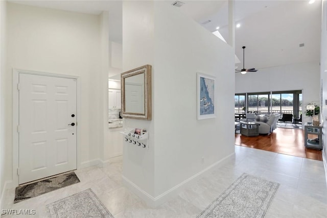 26271 Devonshire Ct Unit 202, Bonita Springs, FL 34134 - foyer with high vaulted ceiling, baseboards, ceiling fan, and light tile patterned floors