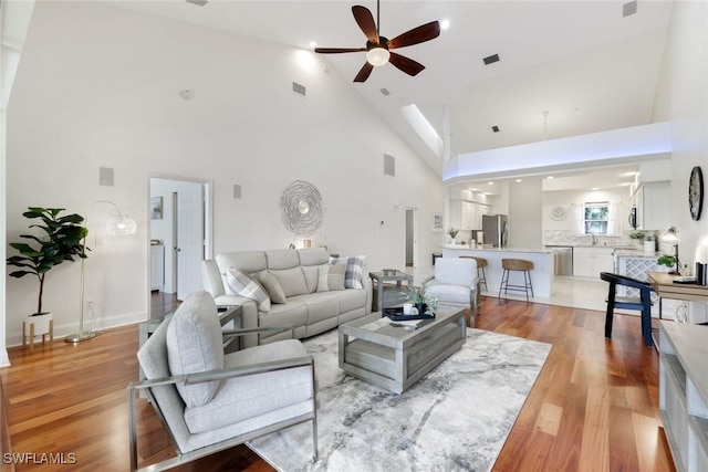 26271 Devonshire Ct Unit 202, Bonita Springs, FL 34134 - living room featuring a ceiling fan, high vaulted ceiling, and light wood-style flooring