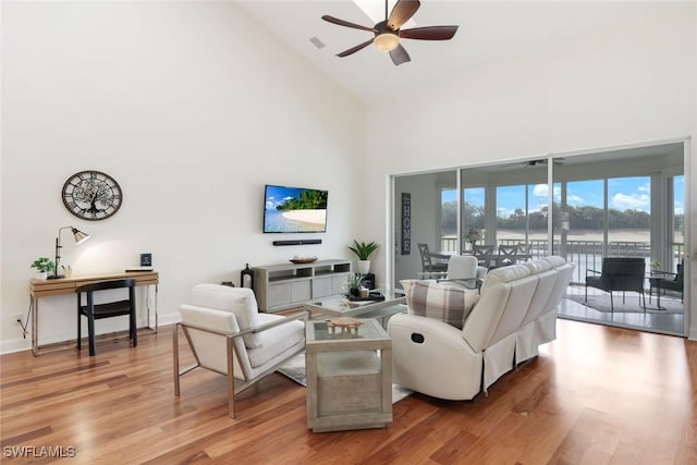 26271 Devonshire Ct Unit 202, Bonita Springs, FL 34134 - living area featuring high vaulted ceiling, ceiling fan, light wood-style flooring, and baseboards