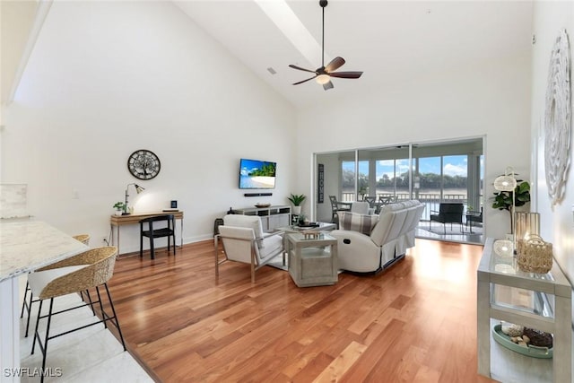 26271 Devonshire Ct Unit 202, Bonita Springs, FL 34134 - living room with high vaulted ceiling, light wood finished floors, and a ceiling fan