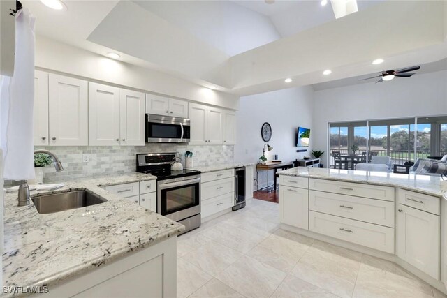 26271 Devonshire Ct Unit 202, Bonita Springs, FL 34134 - kitchen with stainless steel appliances, a sink, a towering ceiling, backsplash, and recessed lighting