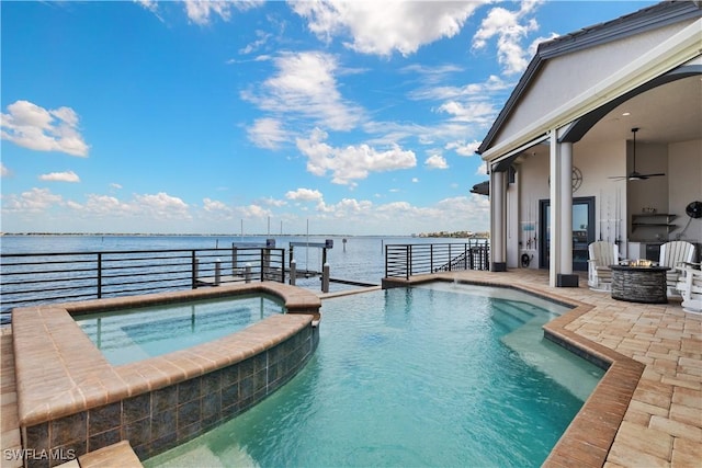 15411 Catalpa Cove Ln, Fort Myers, FL 33908 - view of pool featuring a pool with connected hot tub, a patio area, a ceiling fan, an outdoor fire pit, and a water view