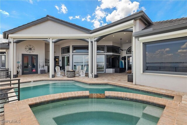 15411 Catalpa Cove Ln, Fort Myers, FL 33908 - back of property featuring a patio area, stucco siding, french doors, and a pool with connected hot tub