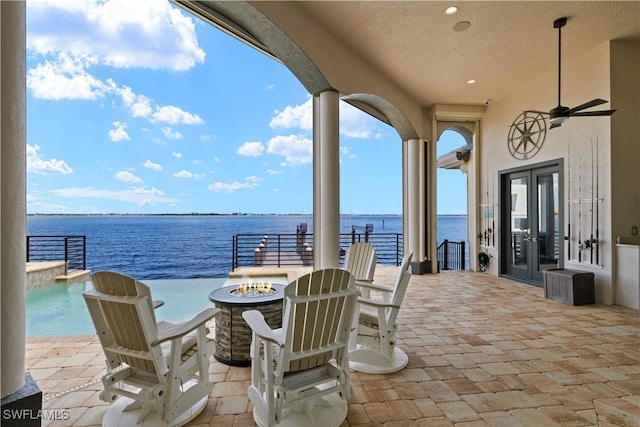 15411 Catalpa Cove Ln, Fort Myers, FL 33908 - view of patio with a water view, a fire pit, and french doors