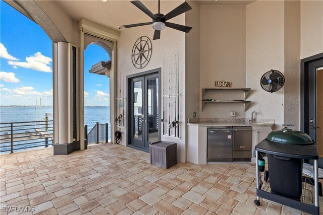15411 Catalpa Cove Ln, Fort Myers, FL 33908 - view of patio / terrace featuring a water view, french doors, and an outdoor kitchen