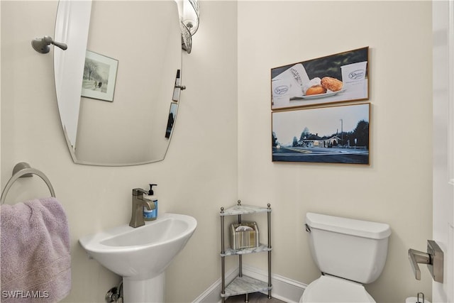 15411 Catalpa Cove Ln, Fort Myers, FL 33908 - half bathroom with a sink, toilet, and baseboards