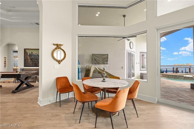 15411 Catalpa Cove Ln, Fort Myers, FL 33908 - dining room with crown molding, baseboards, arched walkways, and wood finished floors
