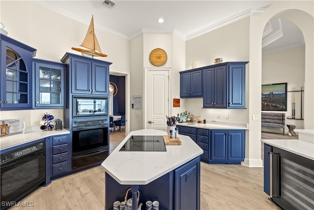 15411 Catalpa Cove Ln, Fort Myers, FL 33908 - kitchen with wine cooler, black appliances, blue cabinets, and a warming drawer