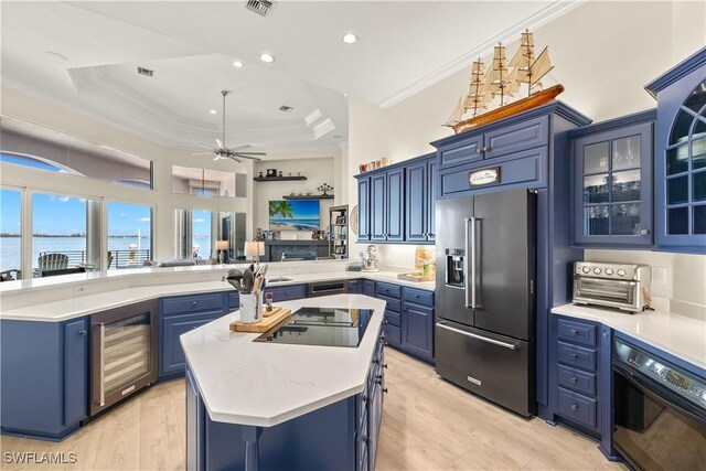 15411 Catalpa Cove Ln, Fort Myers, FL 33908 - kitchen with wine cooler, blue cabinets, a peninsula, crown molding, and black appliances