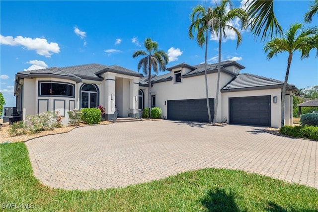 15411 Catalpa Cove Ln, Fort Myers, FL 33908 - view of front of property featuring a garage, stucco siding, and driveway