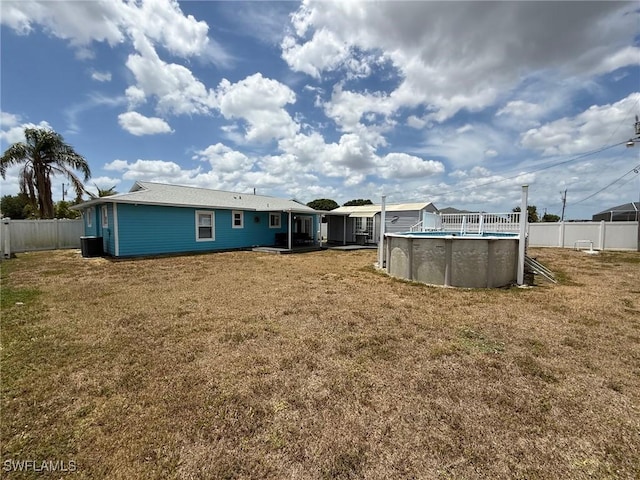 rear view of house featuring central AC