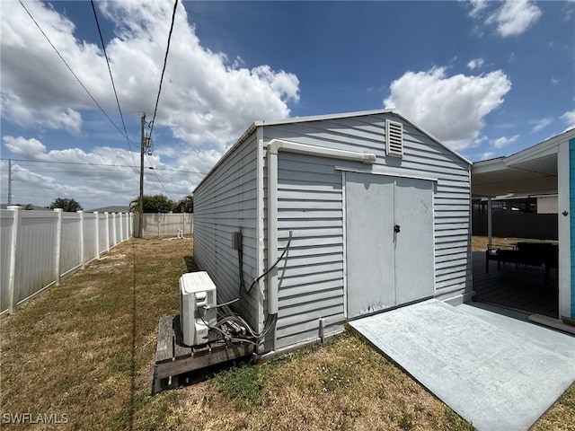 view of shed featuring a fenced backyard and ac unit