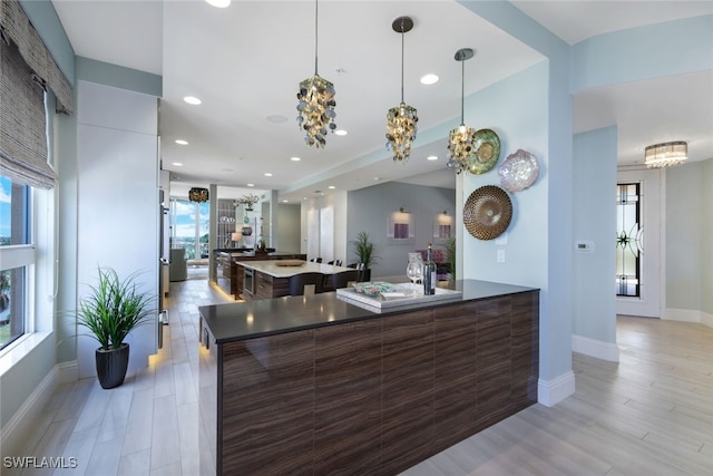 14220 Royal Harbour Ct Unit 607, Fort Myers, FL 33908 - kitchen with modern cabinets, a chandelier, light wood-style floors, recessed lighting, and hanging light fixtures