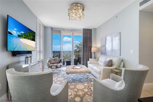 14220 Royal Harbour Ct Unit 607, Fort Myers, FL 33908 - living room featuring plenty of natural light, a chandelier, expansive windows, and wood finished floors