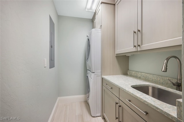 14220 Royal Harbour Ct Unit 607, Fort Myers, FL 33908 - laundry area featuring stacked washer and clothes dryer, cabinet space, and electric panel