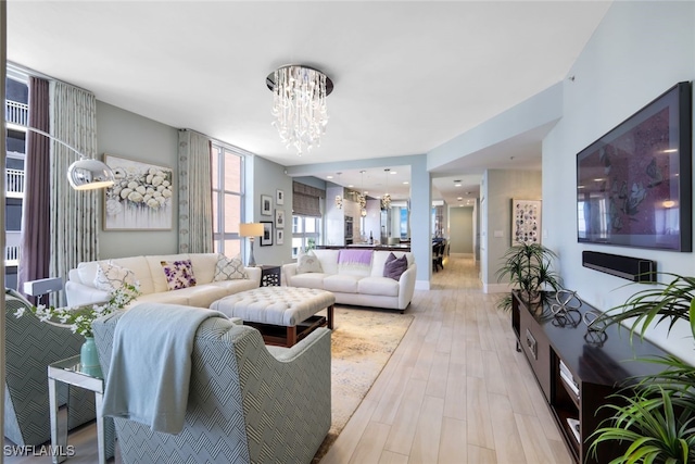 14220 Royal Harbour Ct Unit 607, Fort Myers, FL 33908 - living room featuring a chandelier and light wood-style floors