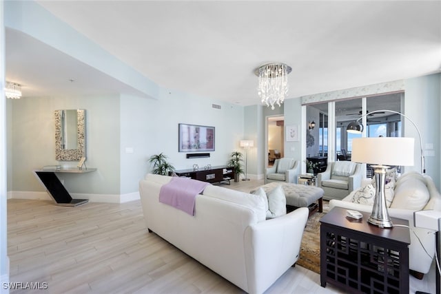 14220 Royal Harbour Ct Unit 607, Fort Myers, FL 33908 - living room with a chandelier and light wood-style floors