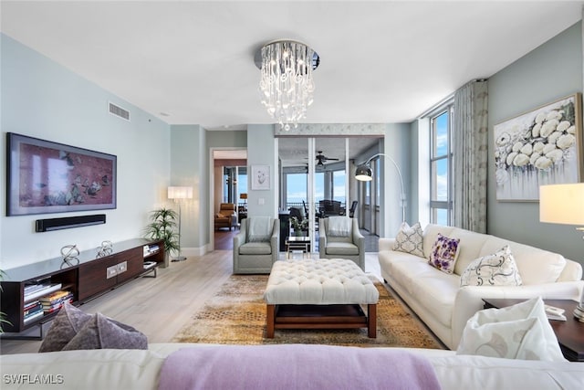 14220 Royal Harbour Ct Unit 607, Fort Myers, FL 33908 - living room with wood finished floors and a chandelier