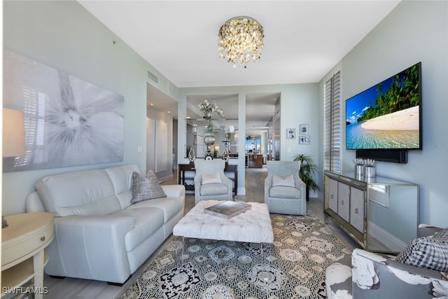 14220 Royal Harbour Ct Unit 607, Fort Myers, FL 33908 - living room with a chandelier and wood finished floors