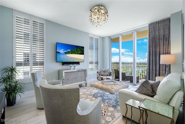14220 Royal Harbour Ct Unit 607, Fort Myers, FL 33908 - living room featuring expansive windows, wood finished floors, and a chandelier