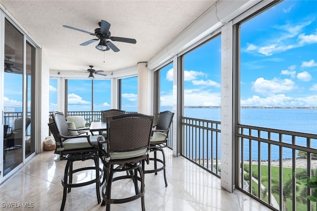 14220 Royal Harbour Ct Unit 607, Fort Myers, FL 33908 - sunroom with a water view, a textured ceiling, and tile patterned floors