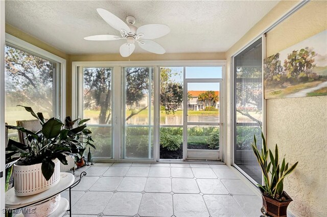 10910 Santa Margherita Rd Unit 101, Estero, FL 34135 - sunroom / solarium featuring a textured ceiling, a textured wall, and tile patterned floors