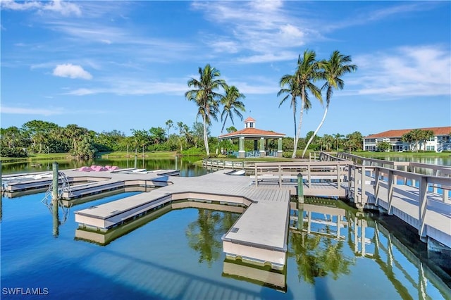 10910 Santa Margherita Rd Unit 101, Estero, FL 34135 - dock area with a gazebo, a water view, and view of scattered trees