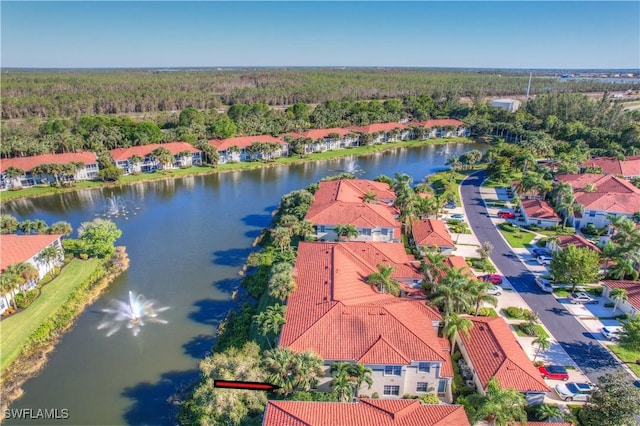 10910 Santa Margherita Rd Unit 101, Estero, FL 34135 - drone / aerial view of a heavily wooded area and a nearby body of water