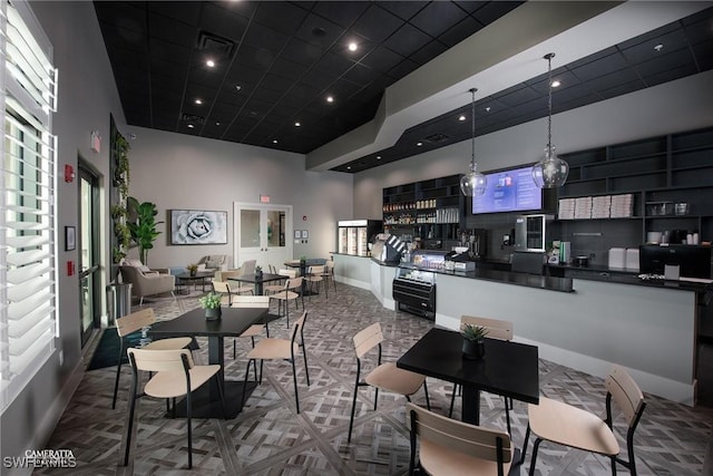 dining area with a high ceiling, baseboards, visible vents, and recessed lighting