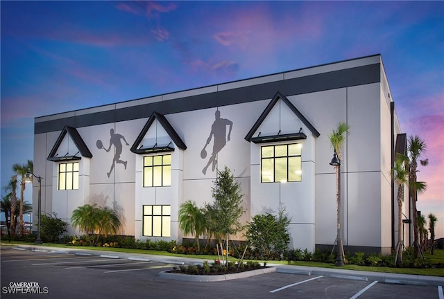 view of building exterior featuring uncovered parking