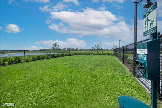 view of yard featuring fence and a rural view