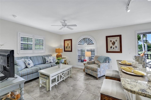 655 8th Ave S Unit 6, Naples, FL 34102 - living area featuring healthy amount of natural light, ceiling fan, light tile patterned floors, and rail lighting