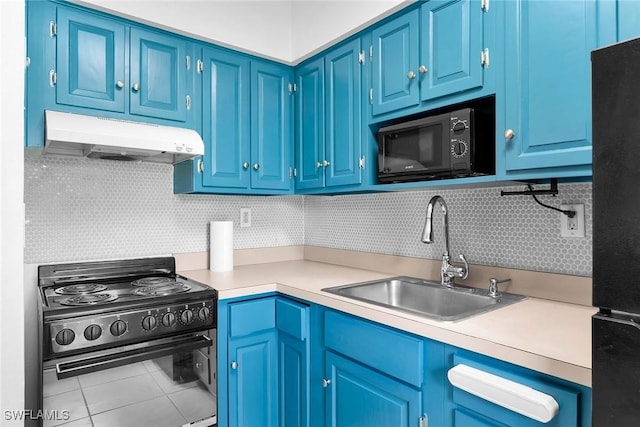 235 Seaview Ct Unit C4, Marco Island, FL 34145 - kitchen featuring black appliances, under cabinet range hood, light countertops, tasteful backsplash, and tile patterned flooring
