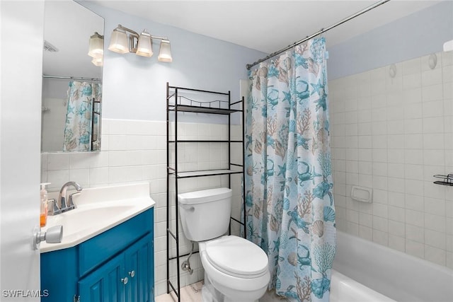 235 Seaview Ct Unit C4, Marco Island, FL 34145 - bathroom with vanity, shower / tub combo with curtain, and tile walls
